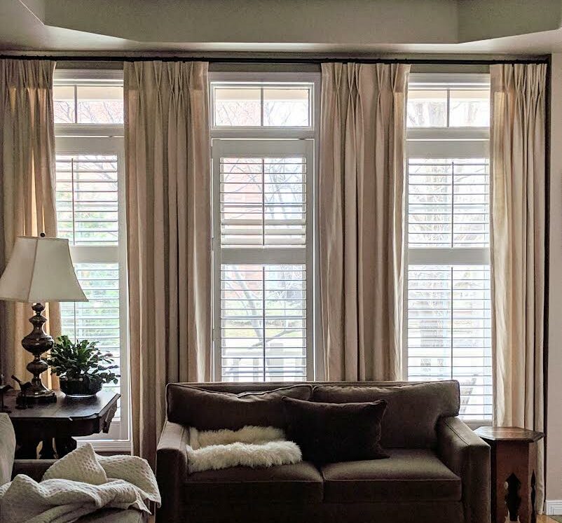 Shutters behind drapes in a sitting/living room