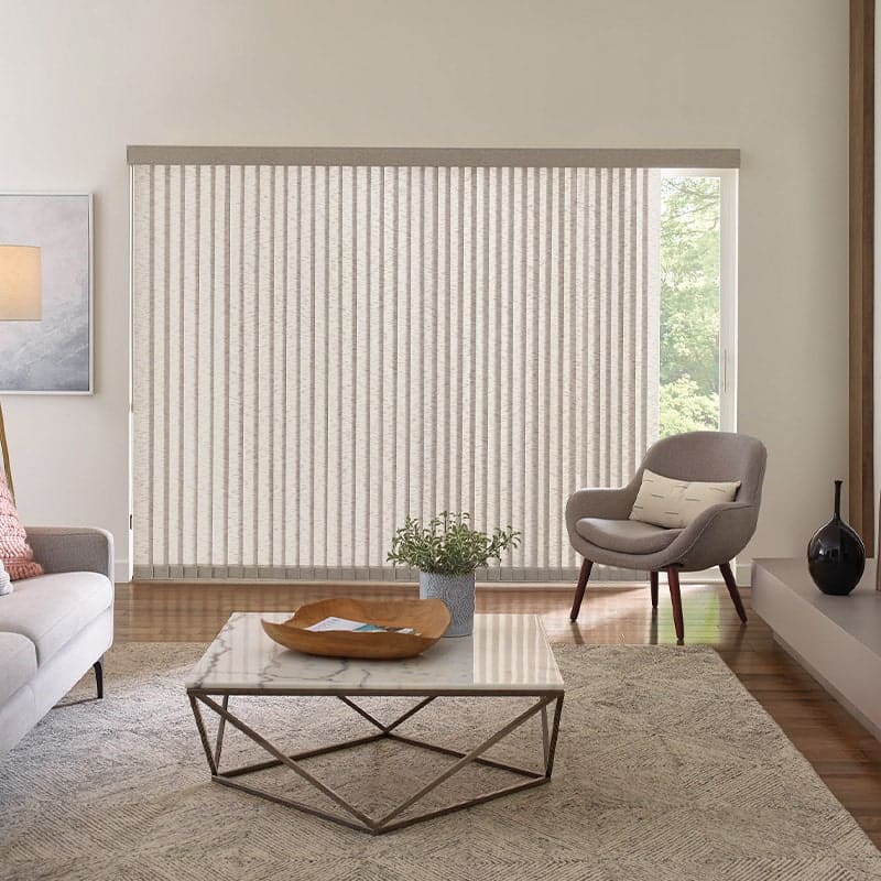 Bright and airy living room with vertical blinds, contemporary furniture, and neutral decor, creating a stylish and functional space for relaxation and natural light.