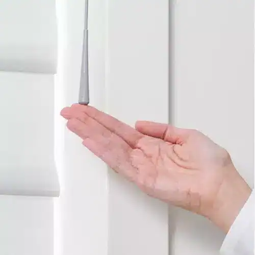 Close-up of hand applying sealant to window frame, ensuring a tight, weatherproof seal for energy efficiency and protection against leaks.