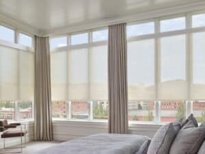 Sun shades window fashions enhancing natural light control and privacy in modern bedroom interiors.
