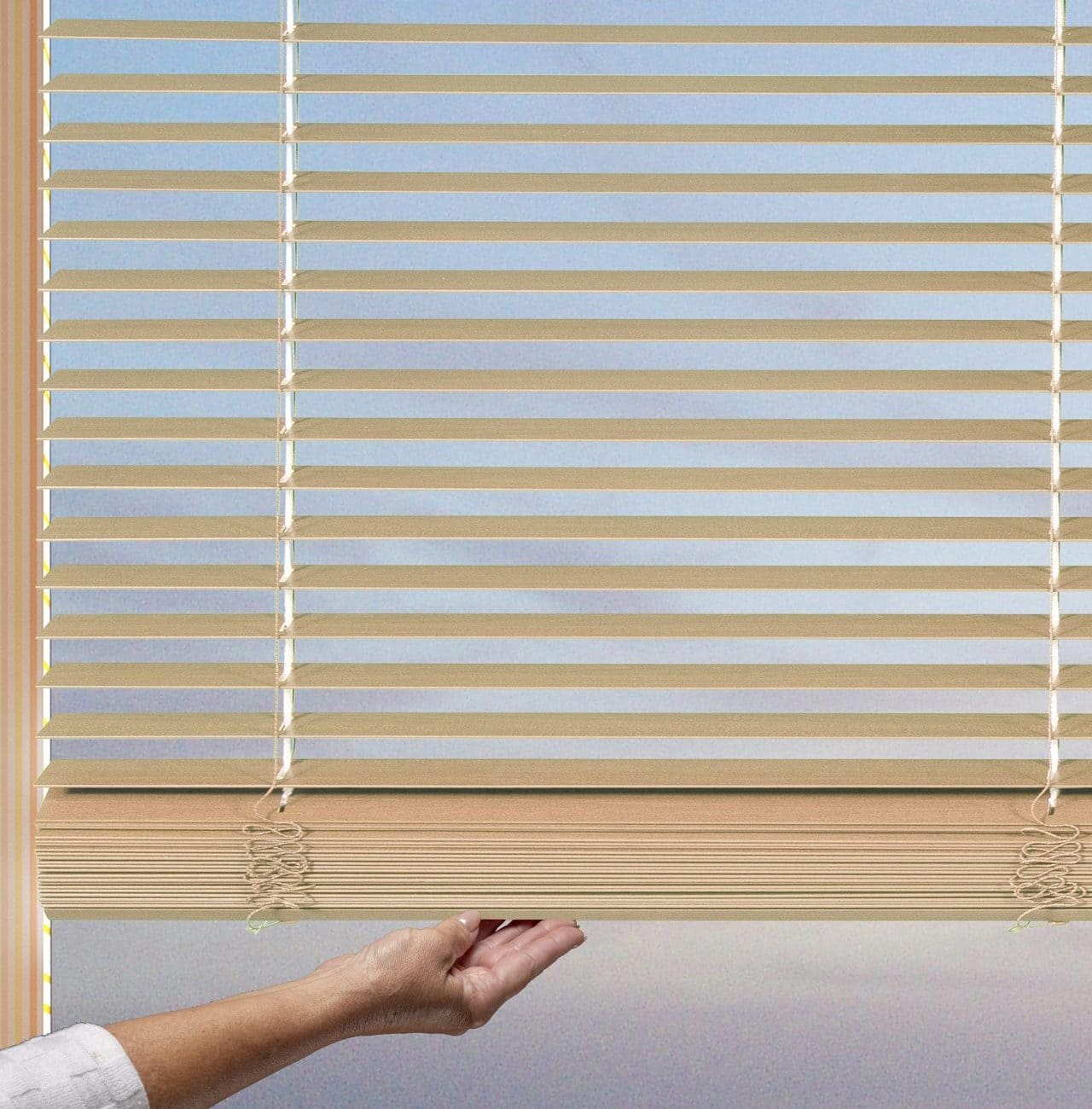 Bright horizontal blinds with a view of the evening sky through the window.