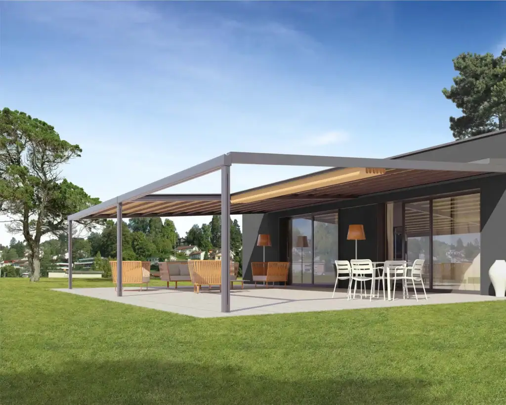 Contemporary outdoor patio with a sleek shade structure, seating area, and scenic green lawn under a clear blue sky.